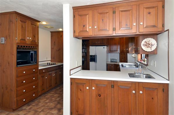 56 Baldpate Road Georgetown, MA 01833 - Photo 9 of 30 a kitchen with a sink a stove and cabinets
