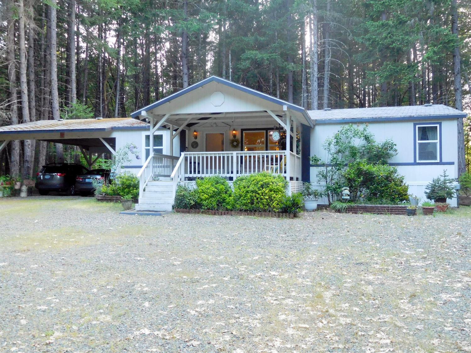 4933 Dick George Road Cave Junction, OR 97523 - Photo 1 of 22 Close up view of front of home, with bac