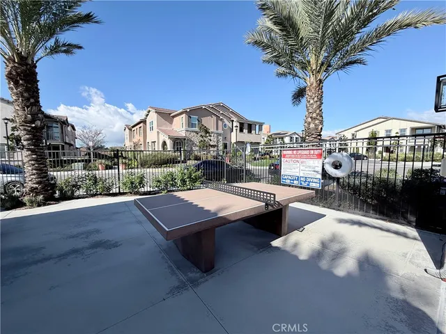 a view of a house with pool and dinning table