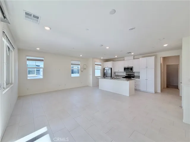 a view of kitchen and refrigerator
