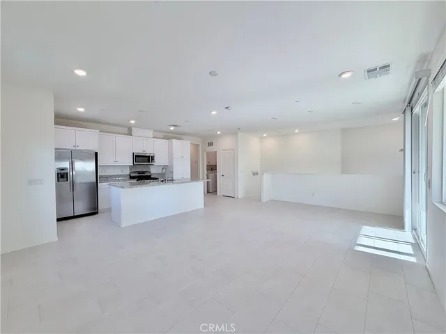 a view of kitchen with refrigerator and kitchen