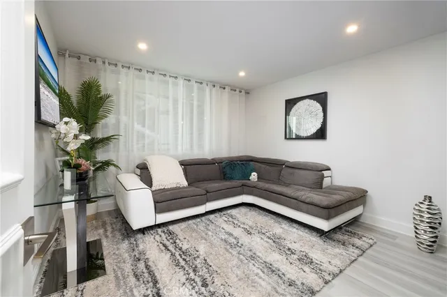 a large bedroom with bed and a chair