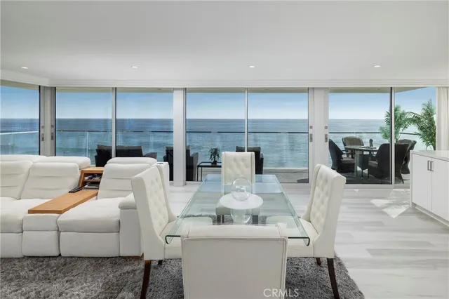 a kitchen with a sink a counter top space and living room view