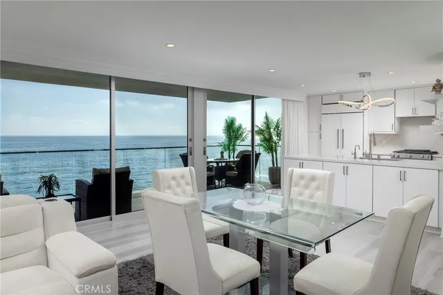 a kitchen with stainless steel appliances granite countertop a sink a stove a refrigerator and cabinets