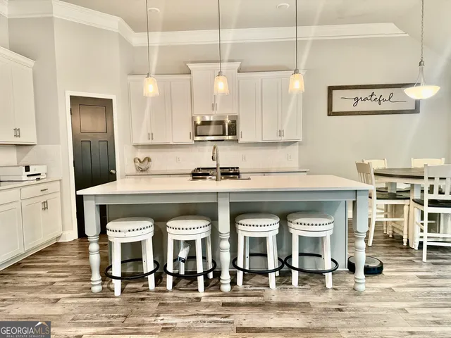 a kitchen with a sink cabinets and appliances