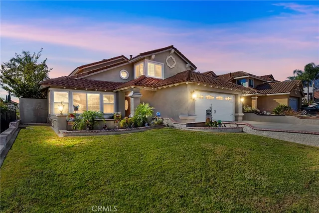 a view of a house with a big yard and potted plants