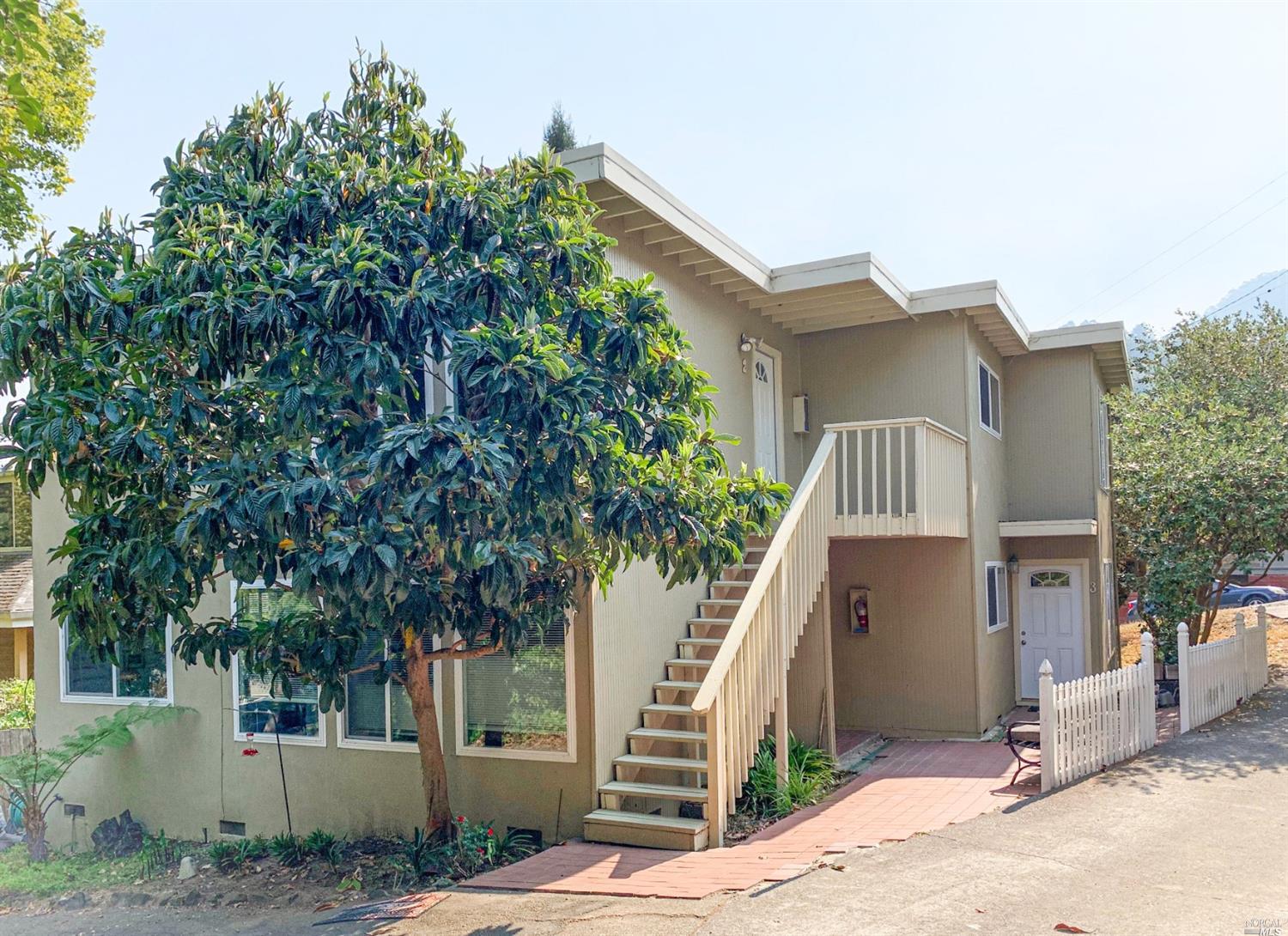 a view of a house with a tree