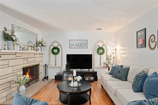 a living room with furniture a fireplace and a flat screen tv