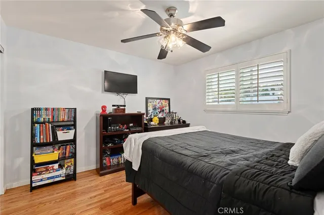 a bedroom with a bed and a book shelf