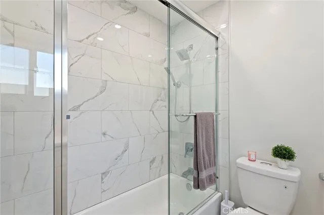 a bathroom with a shower a toilet and a shower