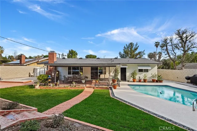 a front view of a house with a yard table and chairs