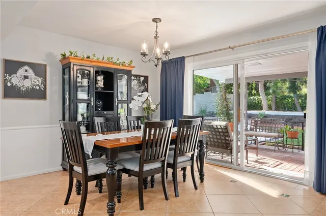 a dining room with furniture a chandelier and window