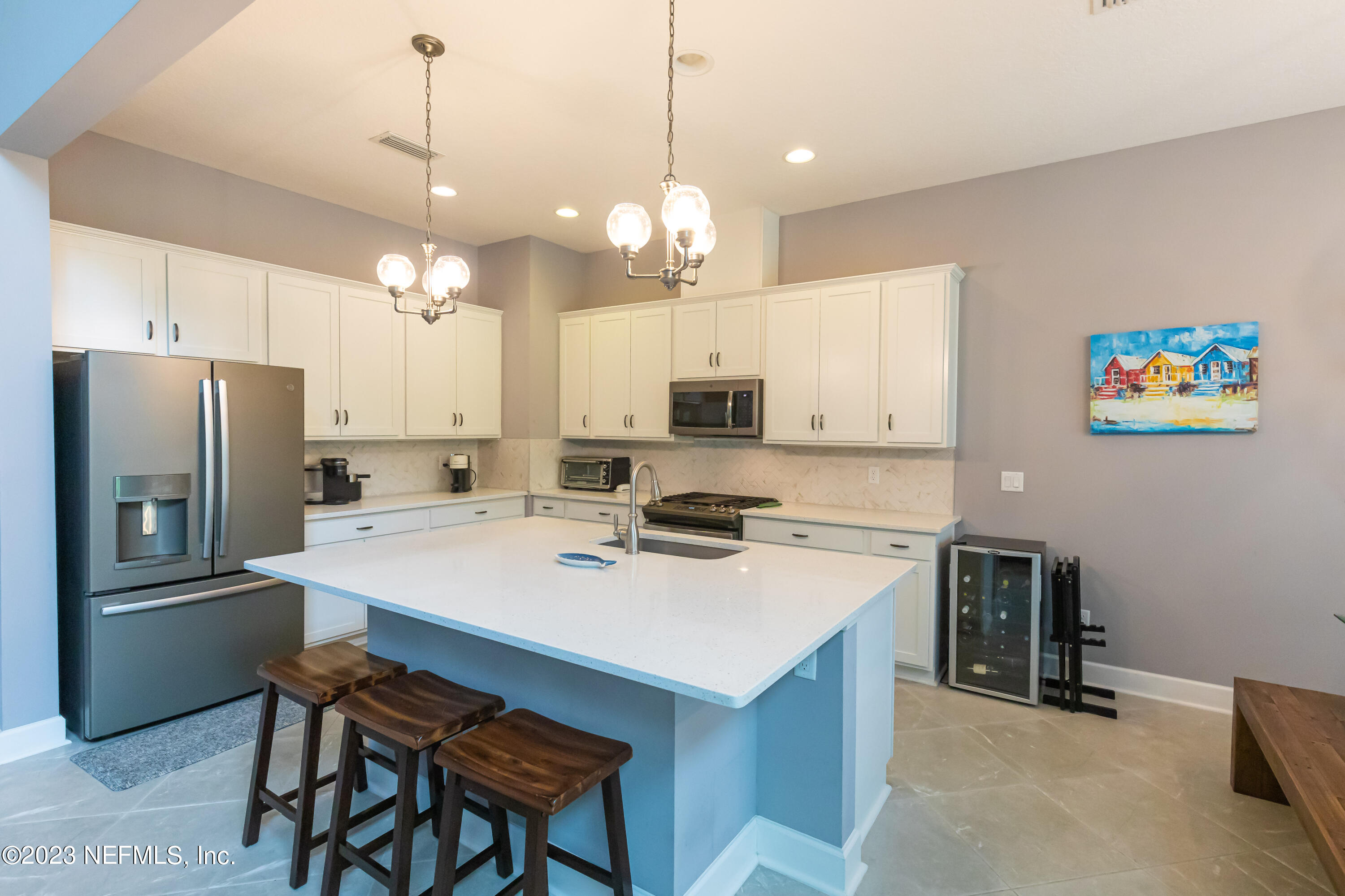 299 Tate Lane St. Johns, FL 32259 - Photo 13 of 55 a kitchen with cabinets a refrigerator a stove a dining table and chairs