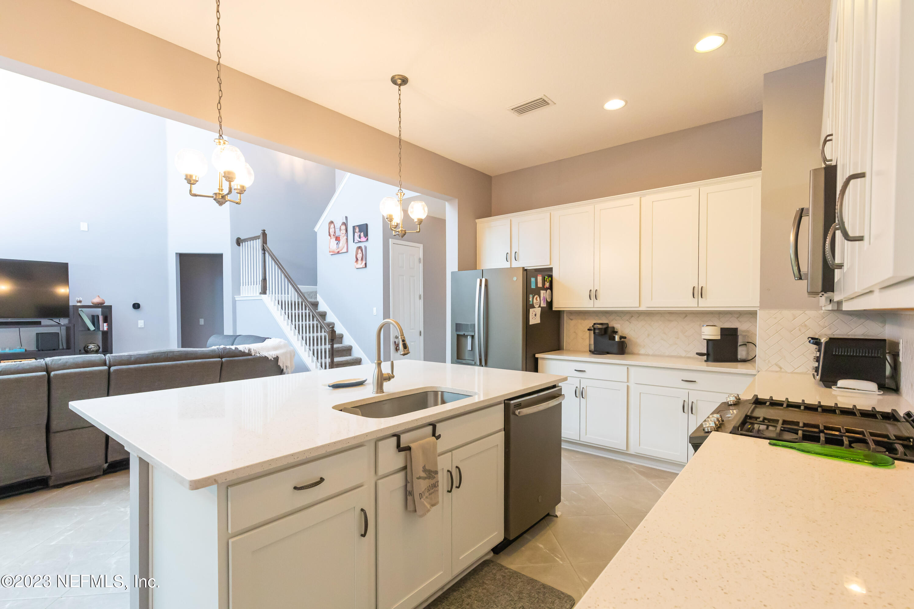 299 Tate Lane St. Johns, FL 32259 - Photo 18 of 55 a kitchen that has a lot of cabinets in it and appliances