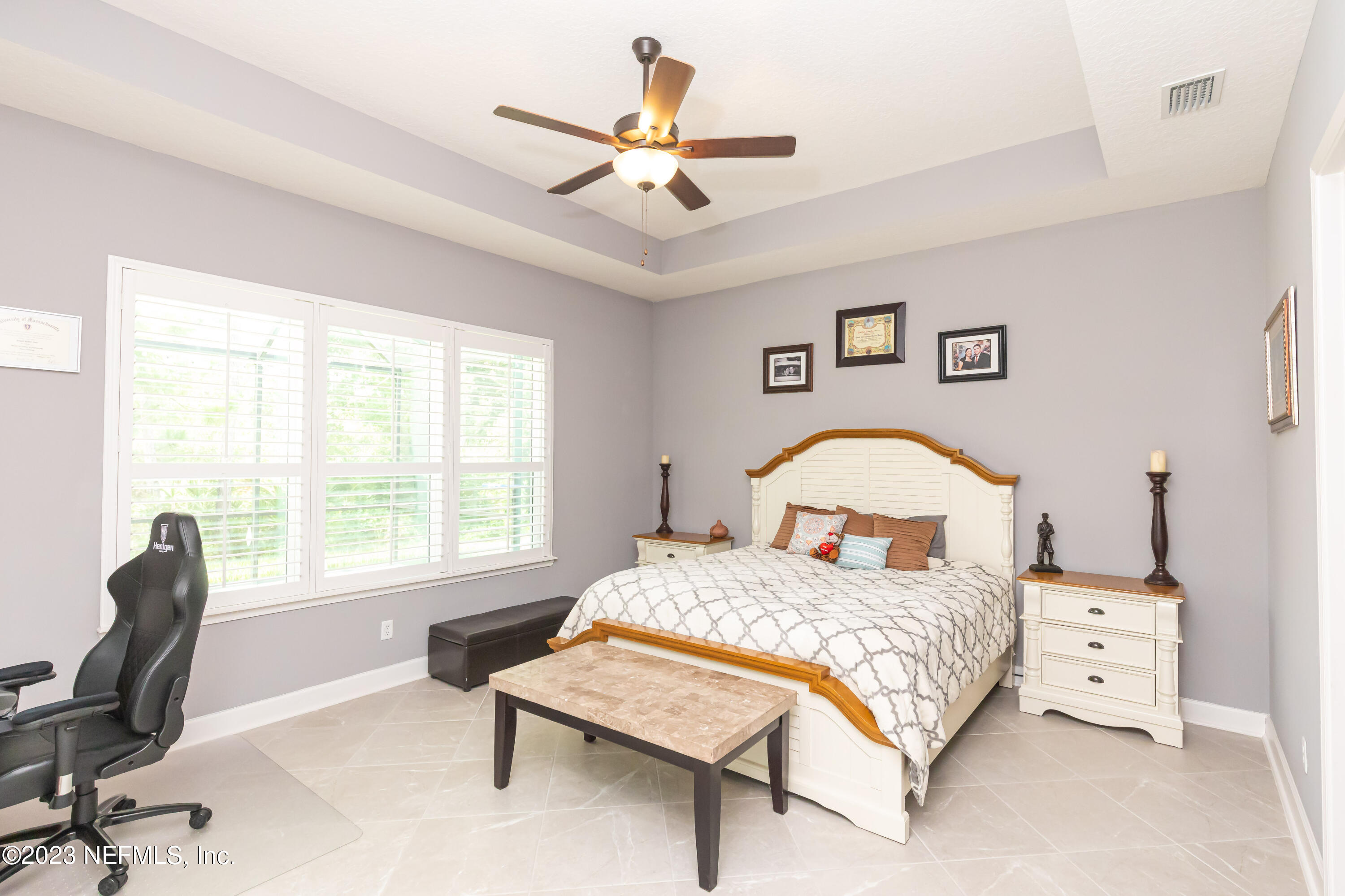 299 Tate Lane St. Johns, FL 32259 - Photo 24 of 55 a bedroom with a bed a computer on desk and a dresser
