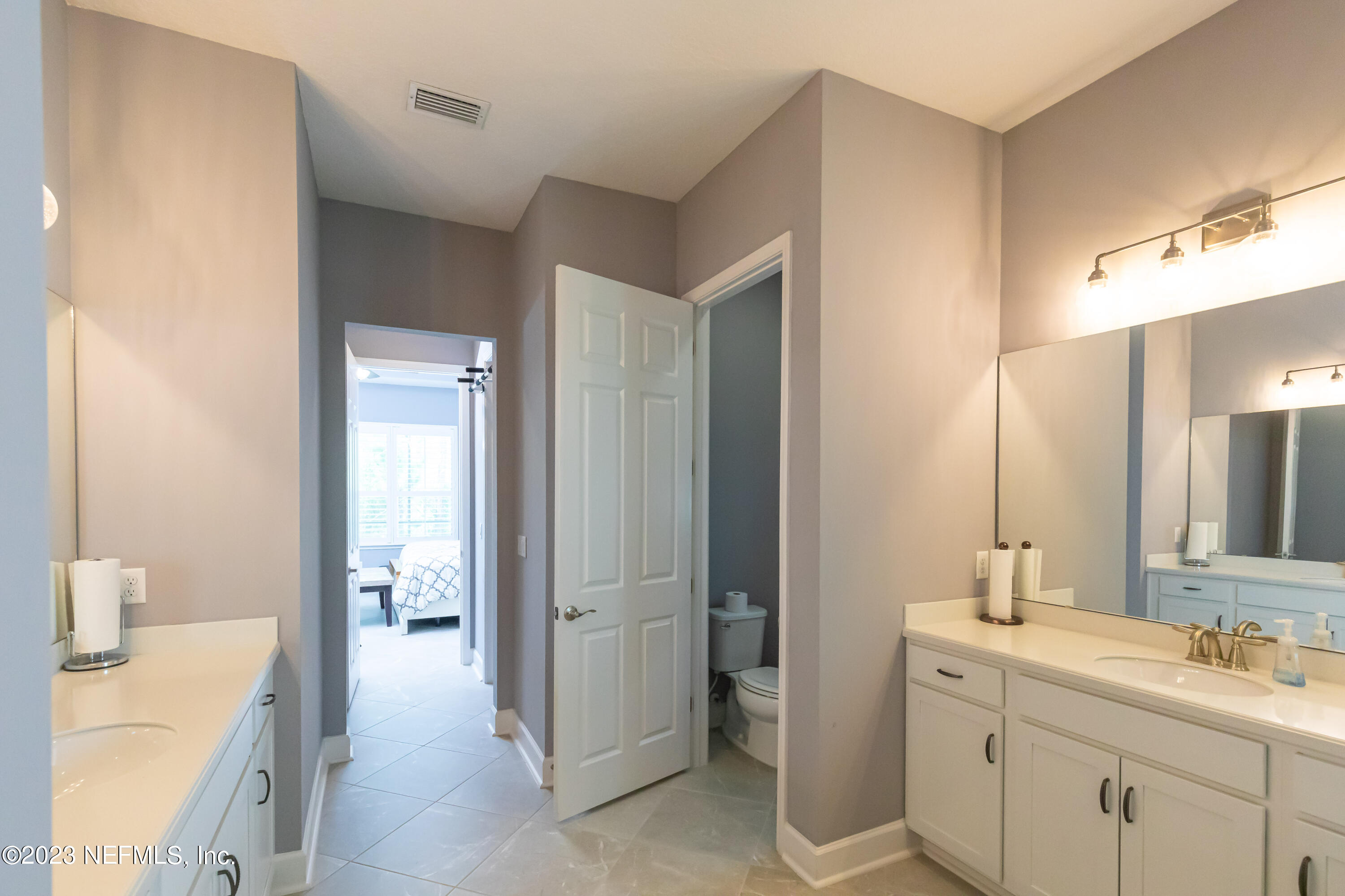 299 Tate Lane St. Johns, FL 32259 - Photo 29 of 55 a en suite bathroom with a sink a mirror and a shower