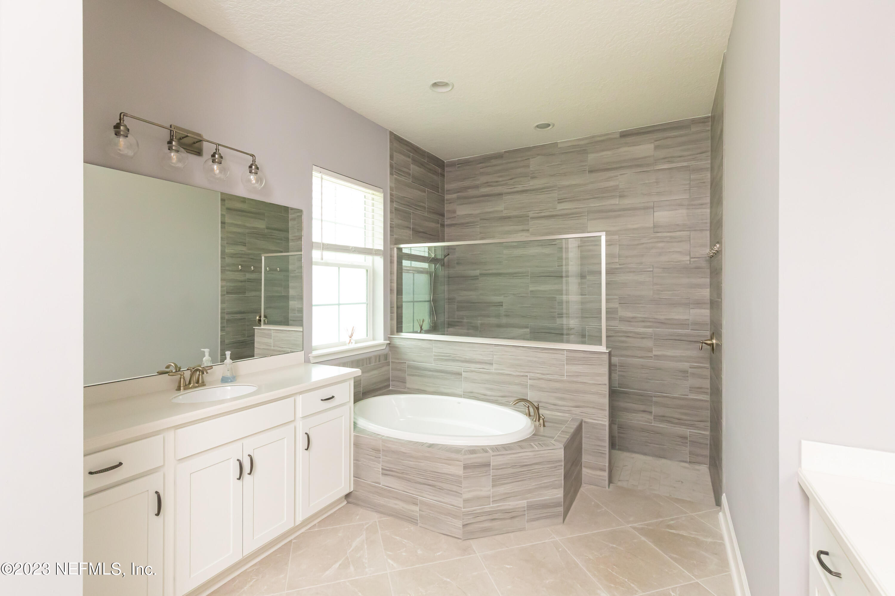 299 Tate Lane St. Johns, FL 32259 - Photo 31 of 55 a bathroom with a double vanity sink a toilet and mirror