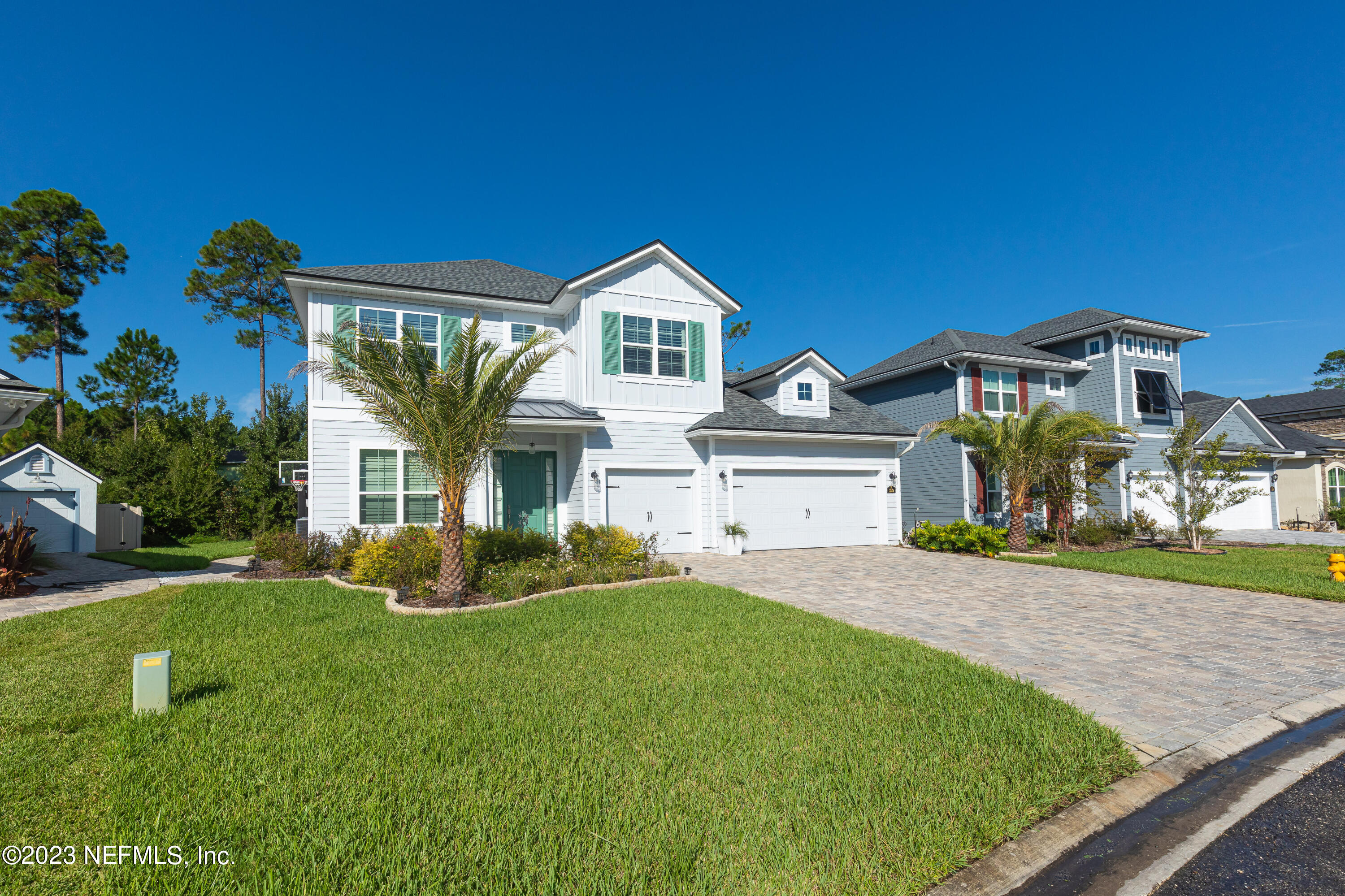 299 Tate Lane St. Johns, FL 32259 - Photo 4 of 55 a front view of a house with a yard and garage