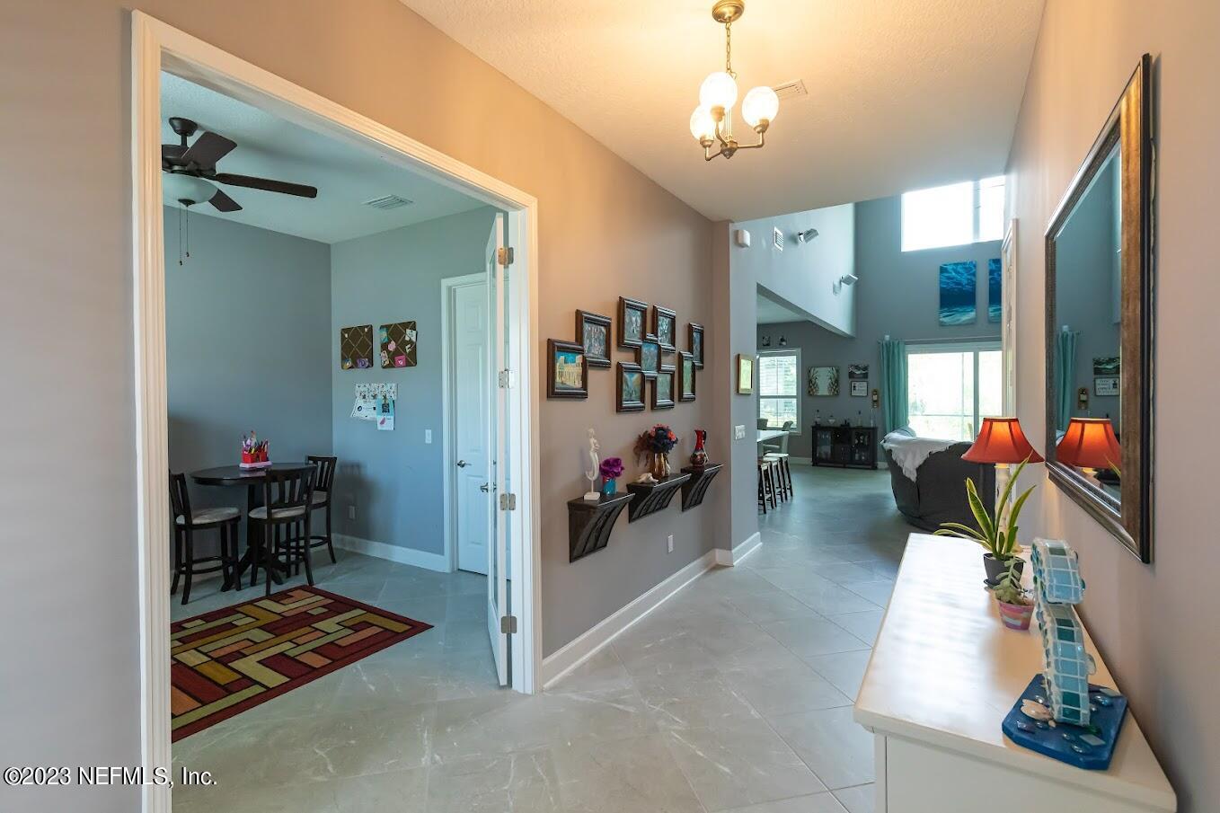 299 Tate Lane St. Johns, FL 32259 - Photo 6 of 55 a room with furniture and a chandelier
