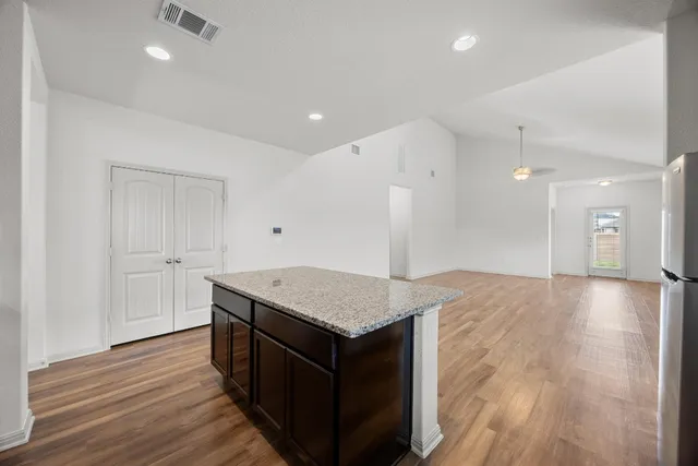 a kitchen with a wooden floor and window