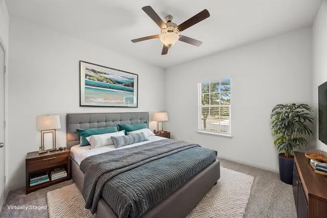 a bedroom with a bed and a potted plant