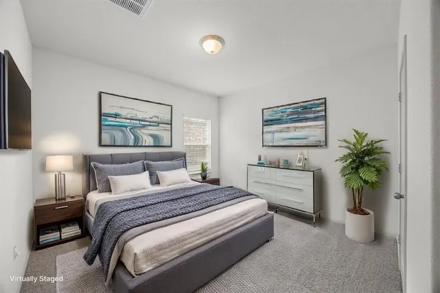 a bedroom with a bed and a potted plant