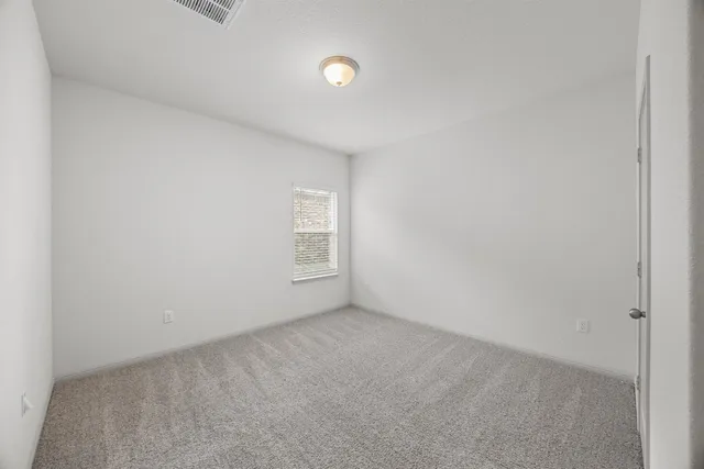 a view of an empty room and a window