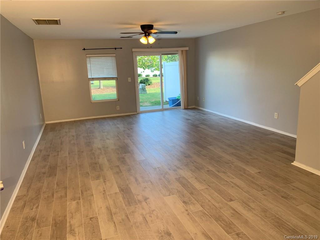 665 Potter Place Road, Unit 105 Fort Mill, SC 29708 - Photo 4 of 14 an empty room with wooden floor and windows