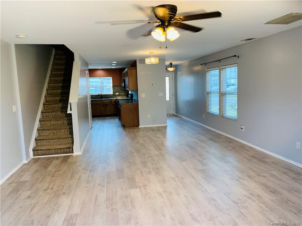665 Potter Place Road, Unit 105 Fort Mill, SC 29708 - Photo 6 of 14 wooden floor in an empty room with a window
