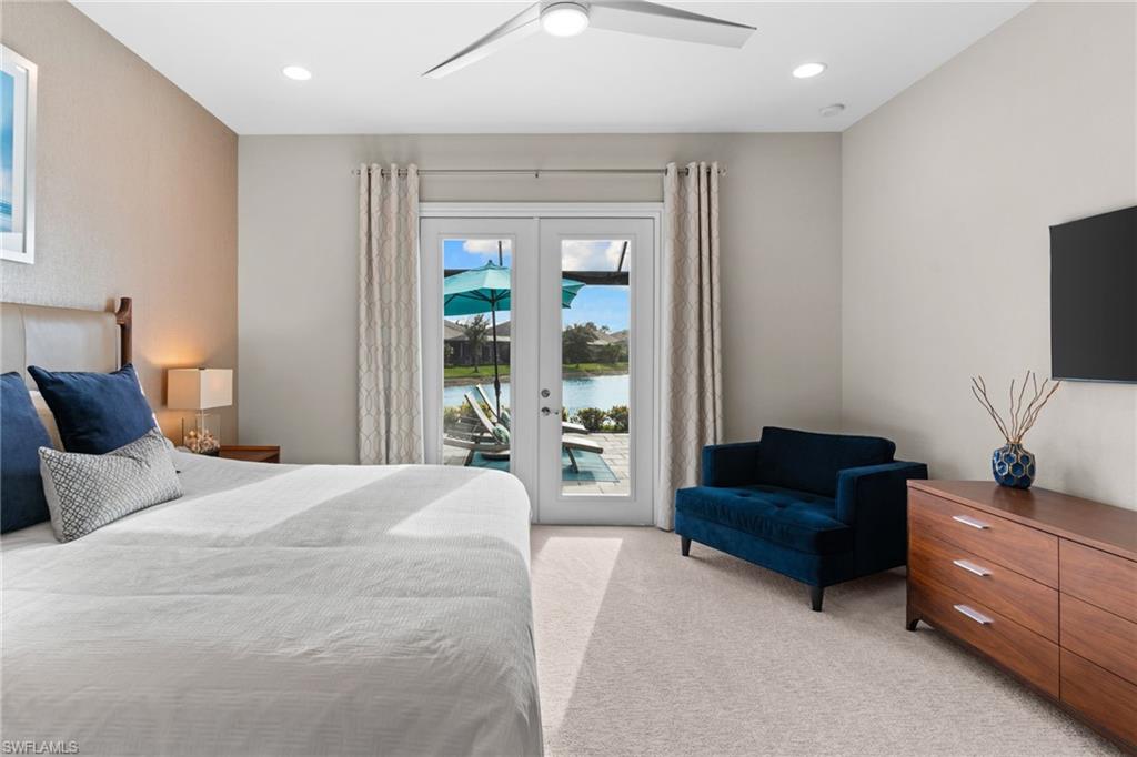 14433 Neptune Avenue Naples, FL 34114 - Photo 12 of 38 a spacious bedroom with a bed window and couch