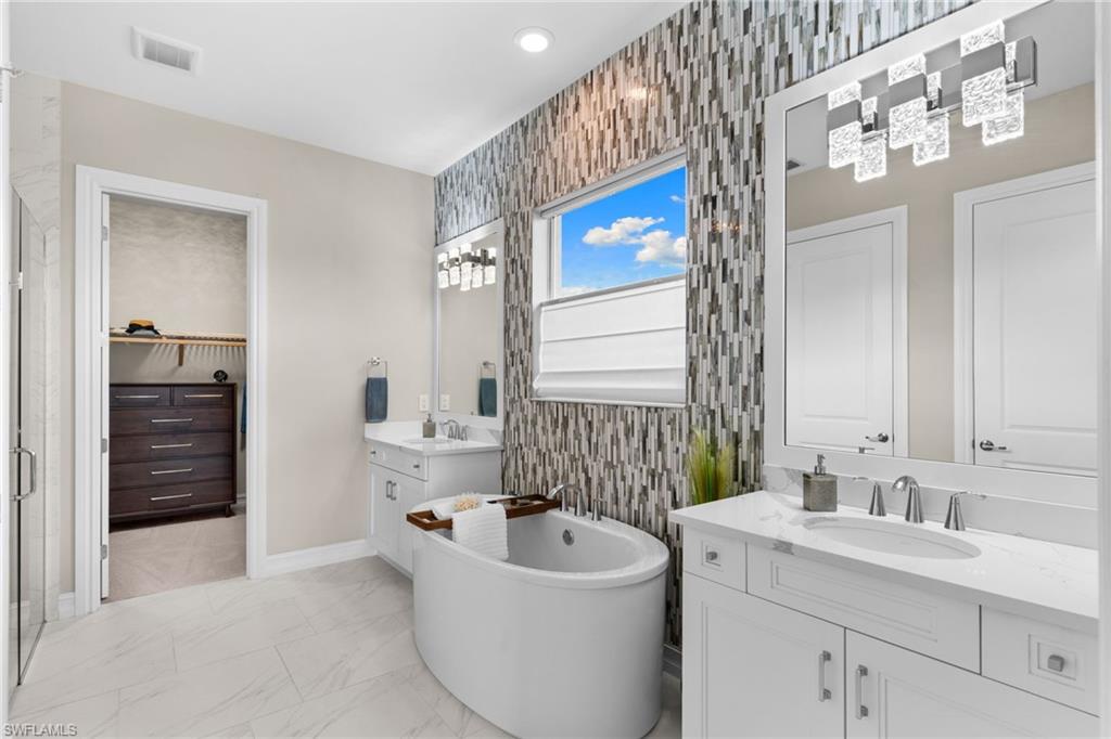 14433 Neptune Avenue Naples, FL 34114 - Photo 13 of 38 a bathroom with a sink and a bathtub