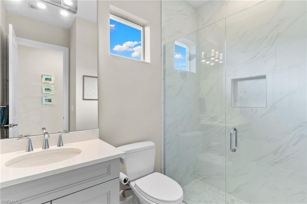 14433 Neptune Avenue Naples, FL 34114 - Photo 15 of 38 a bathroom with a sink a toilet and shower