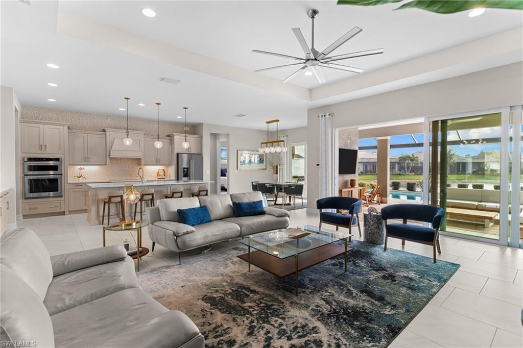 14433 Neptune Avenue Naples, FL 34114 - Photo 24 of 38 a living room with furniture kitchen view and a large window