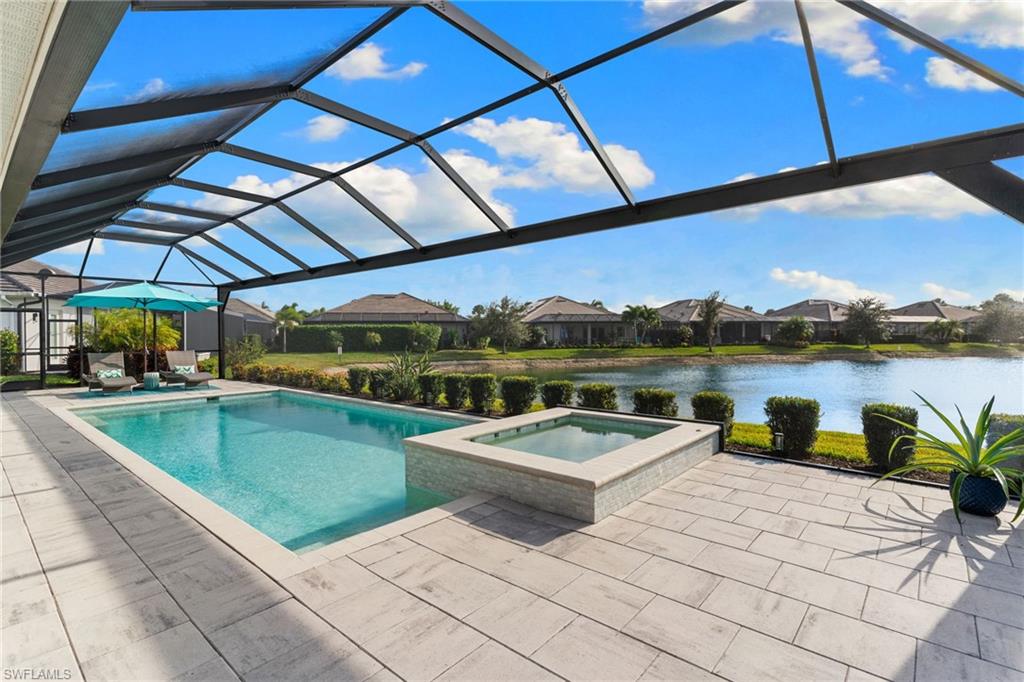 14433 Neptune Avenue Naples, FL 34114 - Photo 25 of 38 a view of a swimming pool with a patio