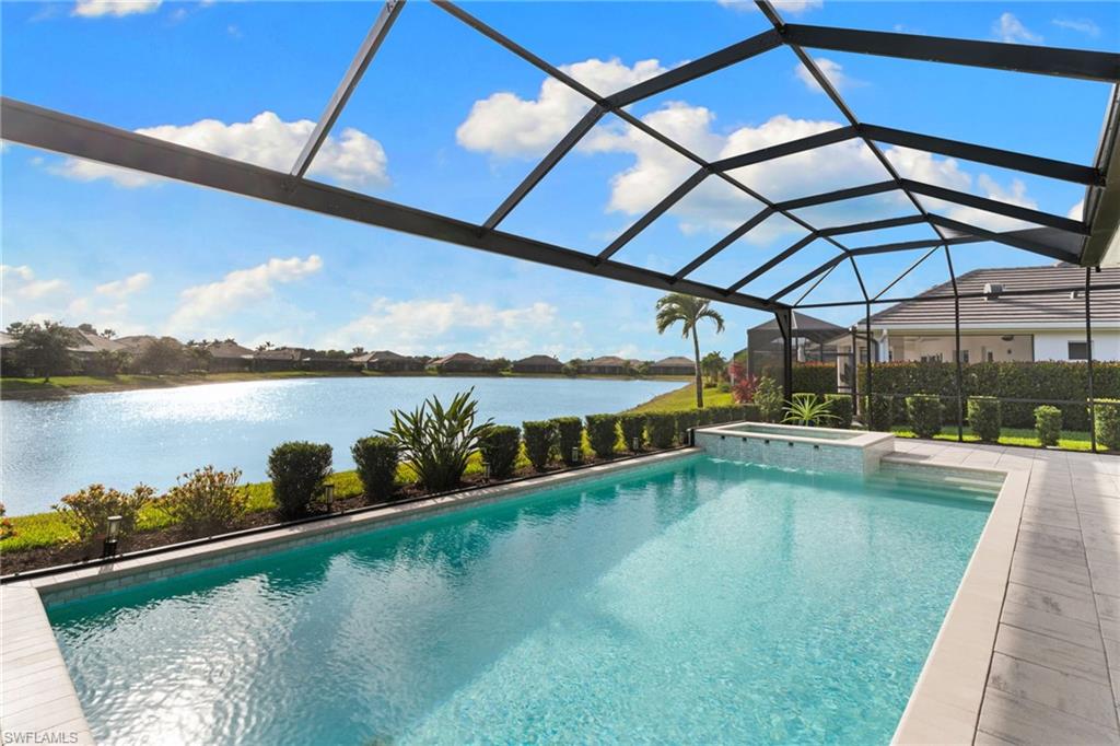 14433 Neptune Avenue Naples, FL 34114 - Photo 28 of 38 a view of a swimming pool with outdoor seating