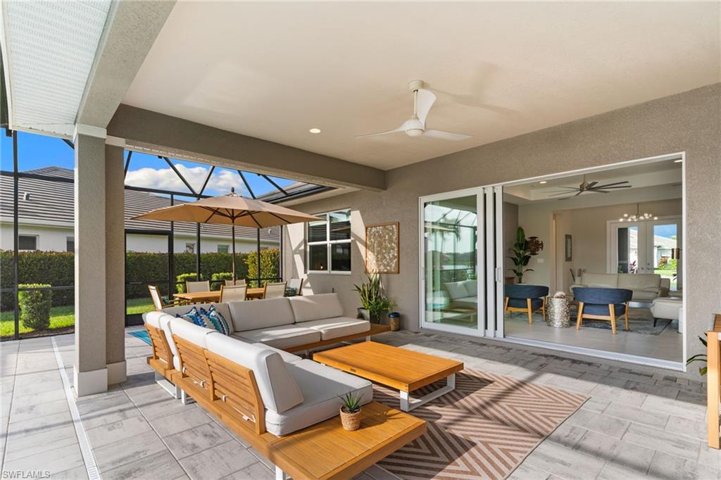 14433 Neptune Avenue Naples, FL 34114 - Photo 29 of 38 a outdoor space with patio the couches and potted plants with the view of living room