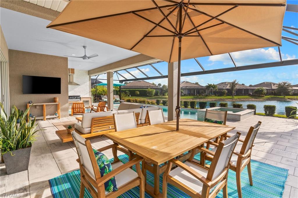 14433 Neptune Avenue Naples, FL 34114 - Photo 4 of 38 a view of an outdoor space with furniture and umbrella