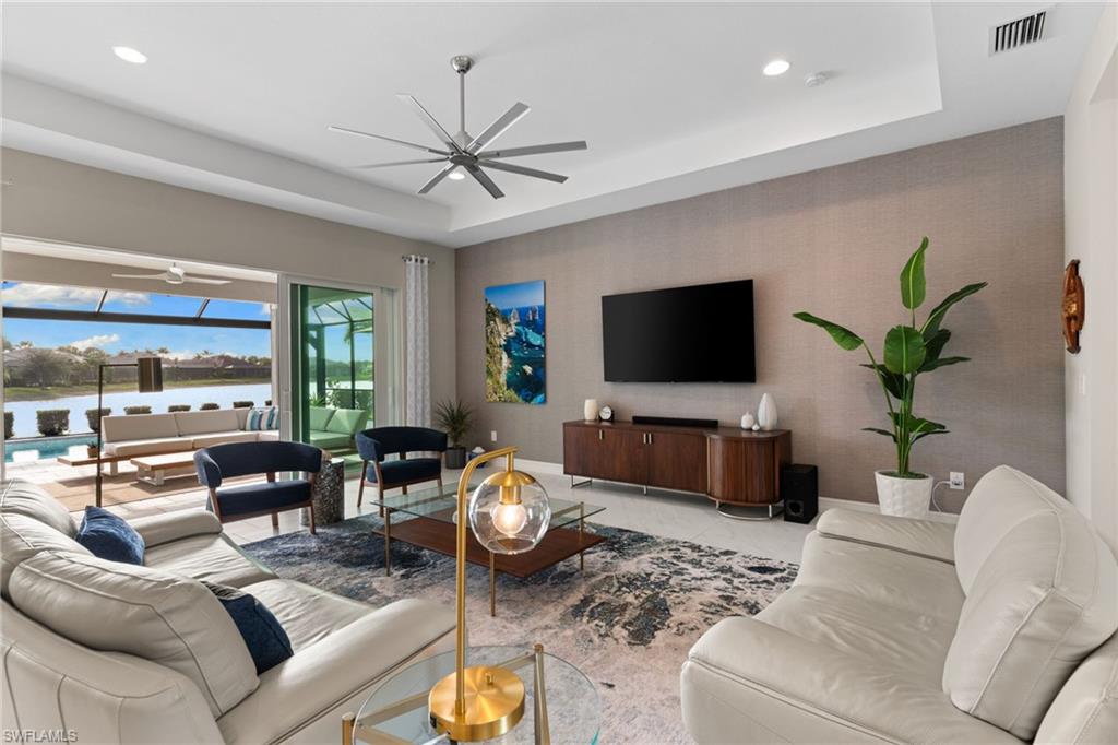 14433 Neptune Avenue Naples, FL 34114 - Photo 9 of 38 a living room with furniture and a flat screen tv