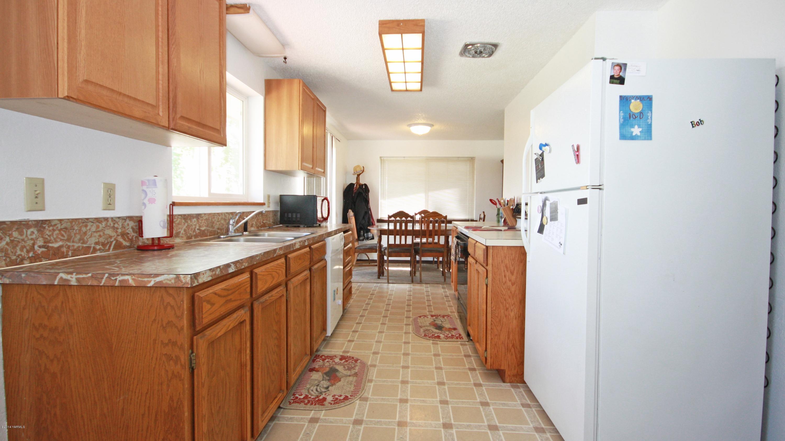 12070 Mieras Road Moxee, WA 98936 - Photo 3 of 30 a kitchen with stainless steel appliances granite countertop a sink and cabinets