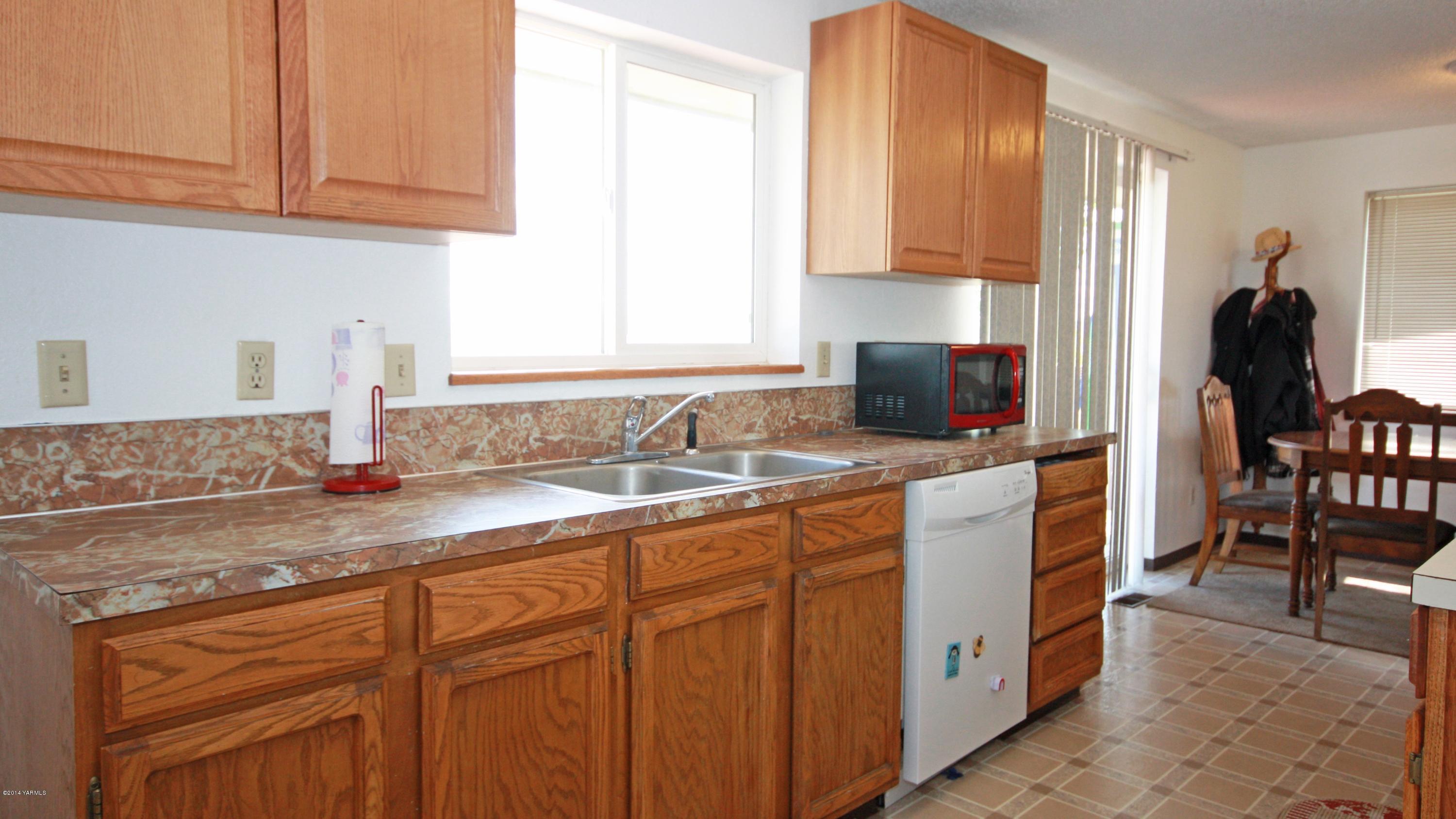 12070 Mieras Road Moxee, WA 98936 - Photo 4 of 30 a kitchen with stainless steel appliances granite countertop a sink stove and cabinets