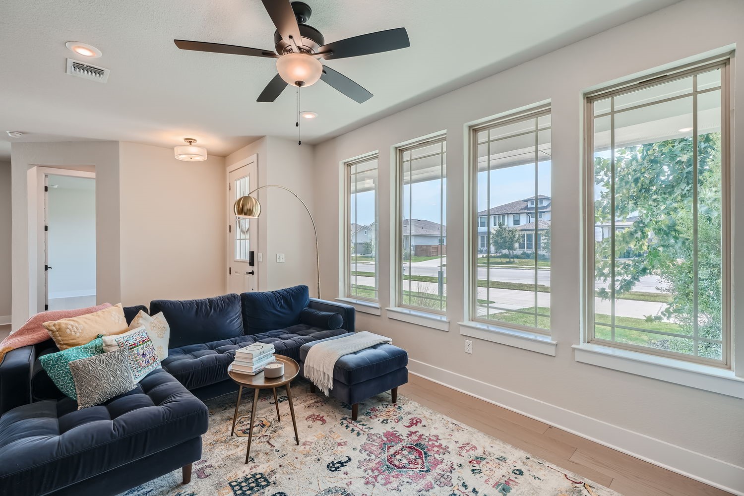 8319 Laughlin Lane Austin, TX 78744 - Photo 4 of 26 Upon entering, you'll be greeted by beautiful light wood floors that flow through the open-concept living areas, where large windows fill the space in natural light.