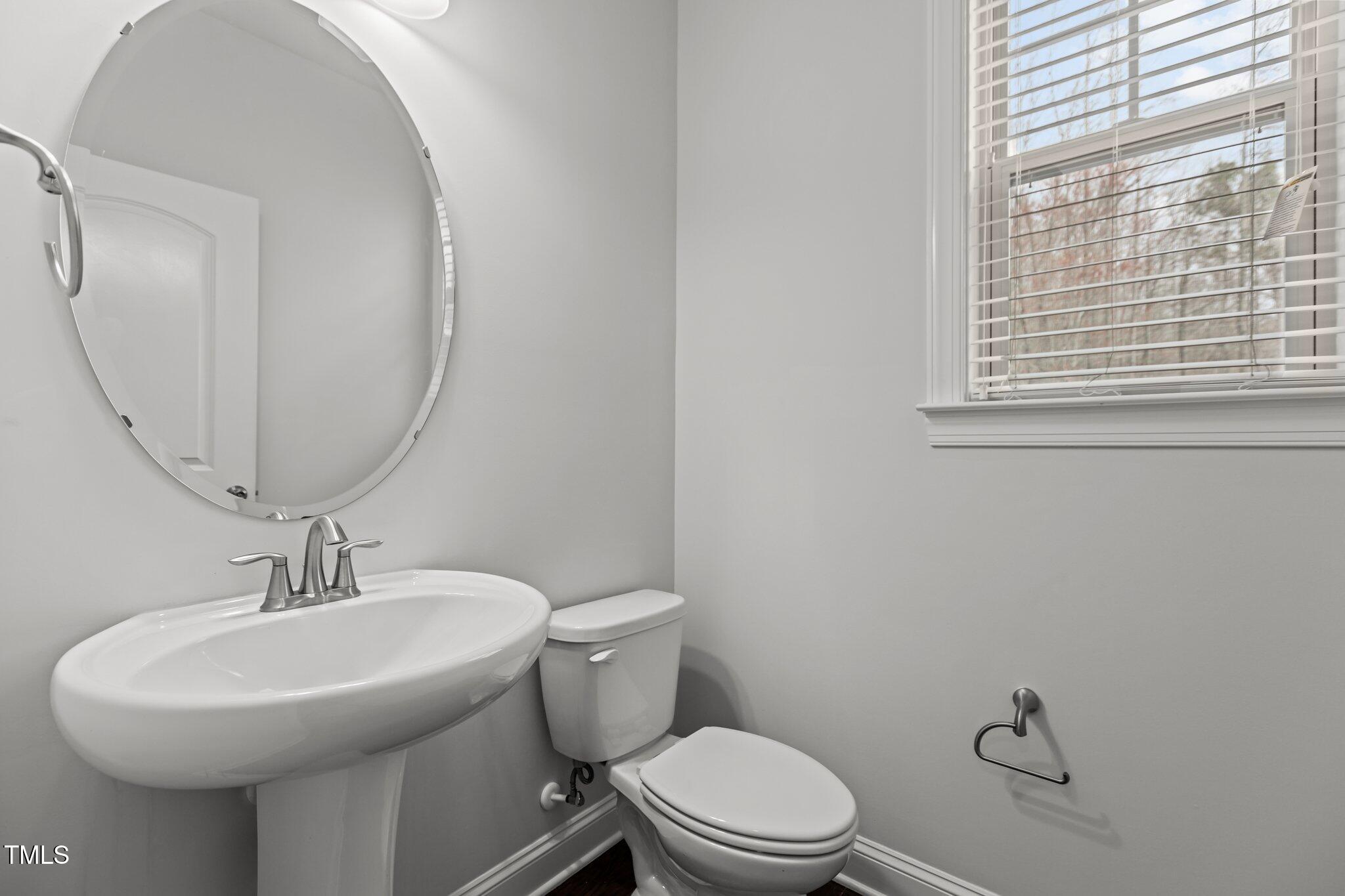 1800 Bodwin Lane Apex, NC 27502 - Photo 8 of 63 a bathroom with a toilet sink and mirror