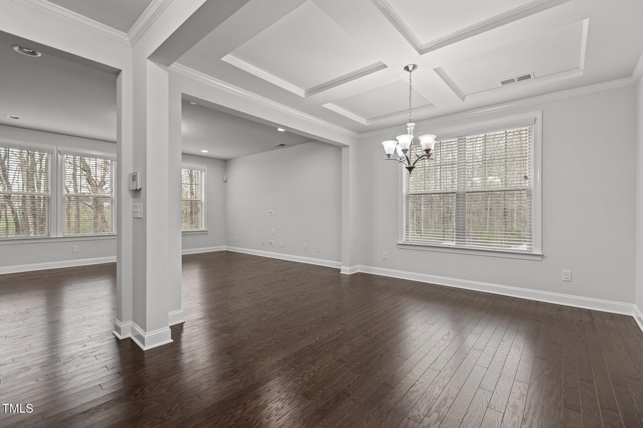1800 Bodwin Lane Apex, NC 27502 - Photo 9 of 63 a view of an empty room with wooden floor and a window