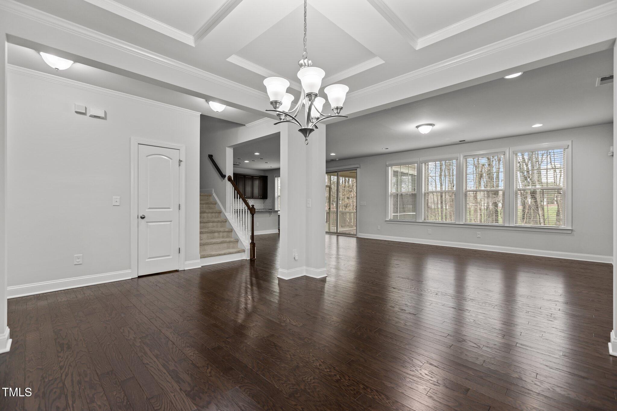 1800 Bodwin Lane Apex, NC 27502 - Photo 10 of 63 a view of an empty room with wooden floor and a window