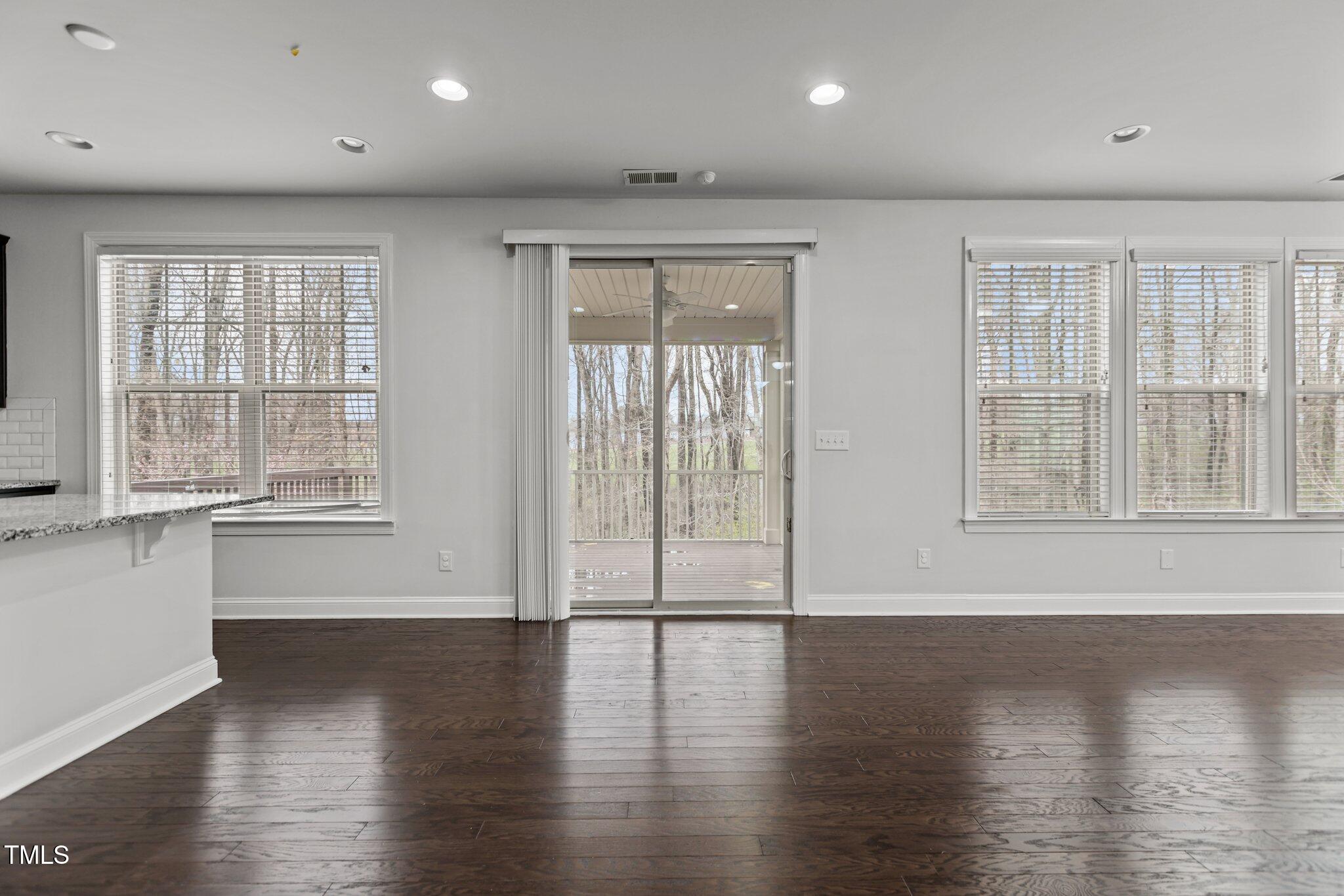 1800 Bodwin Lane Apex, NC 27502 - Photo 15 of 63 a view of an empty room with wooden floor and a window