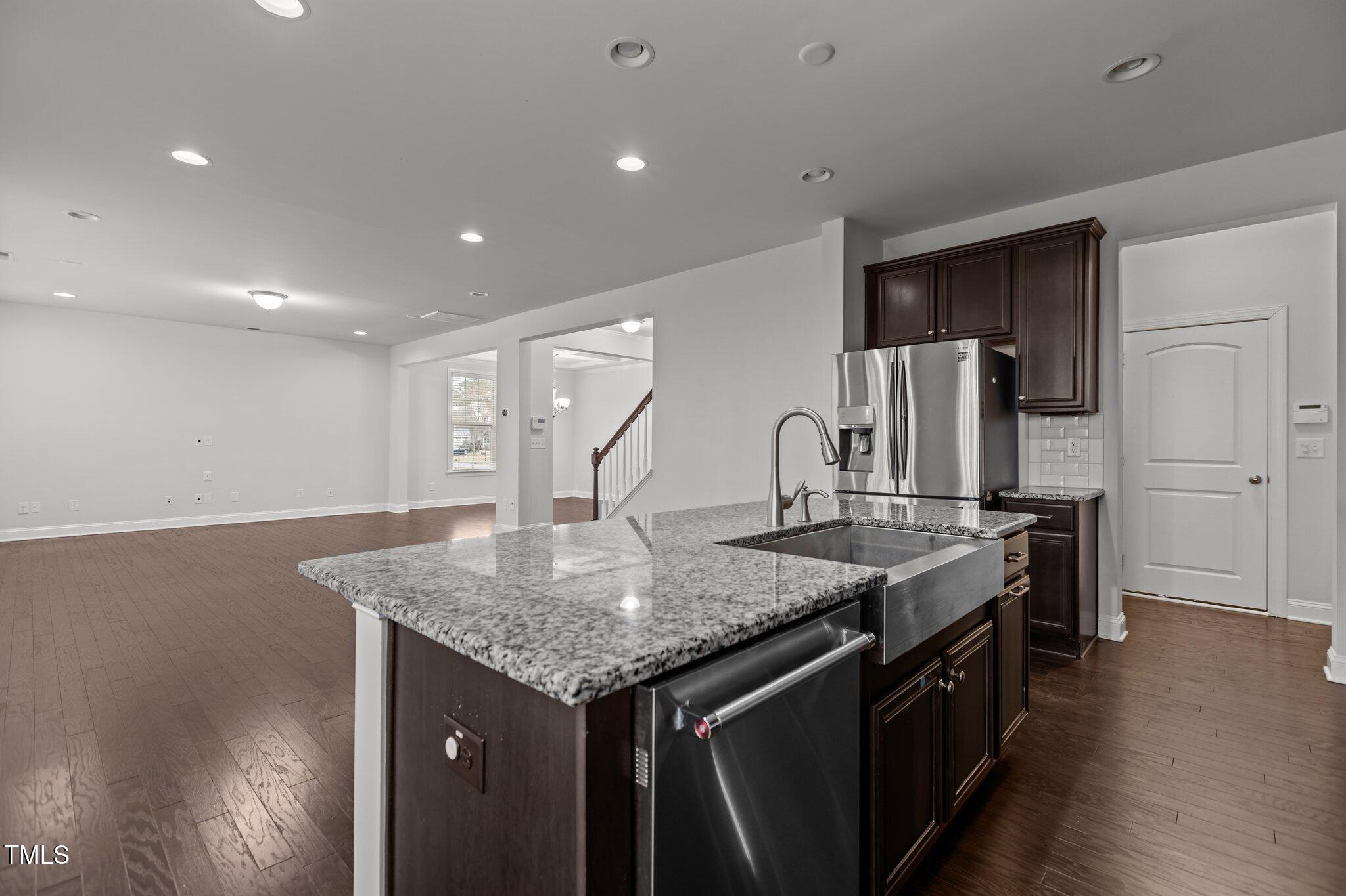 1800 Bodwin Lane Apex, NC 27502 - Photo 19 of 63 a kitchen with stainless steel appliances granite countertop a sink a stove and a refrigerator