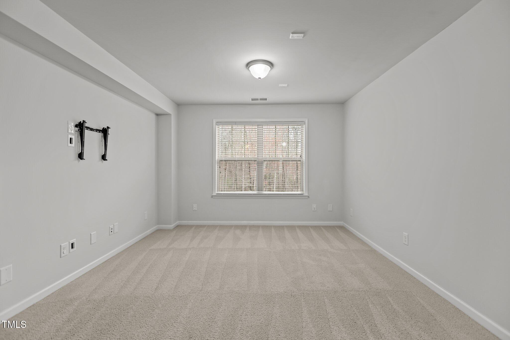 1800 Bodwin Lane Apex, NC 27502 - Photo 21 of 63 wooden floor in an empty room with a window