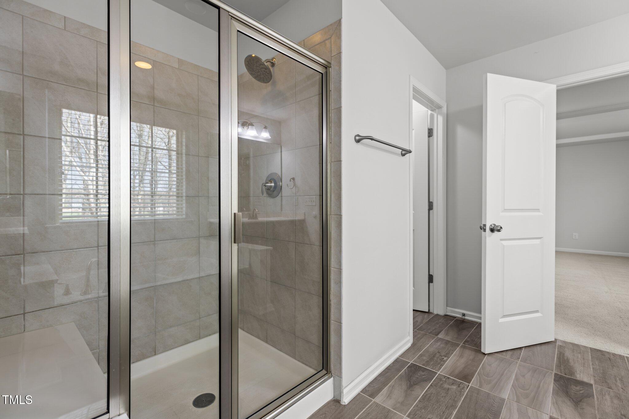 1800 Bodwin Lane Apex, NC 27502 - Photo 26 of 63 a bathroom with a glass shower door