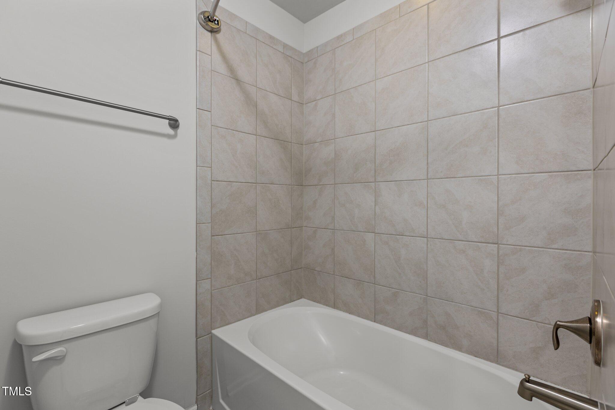 1800 Bodwin Lane Apex, NC 27502 - Photo 37 of 63 a bathroom with a toilet and bathtub