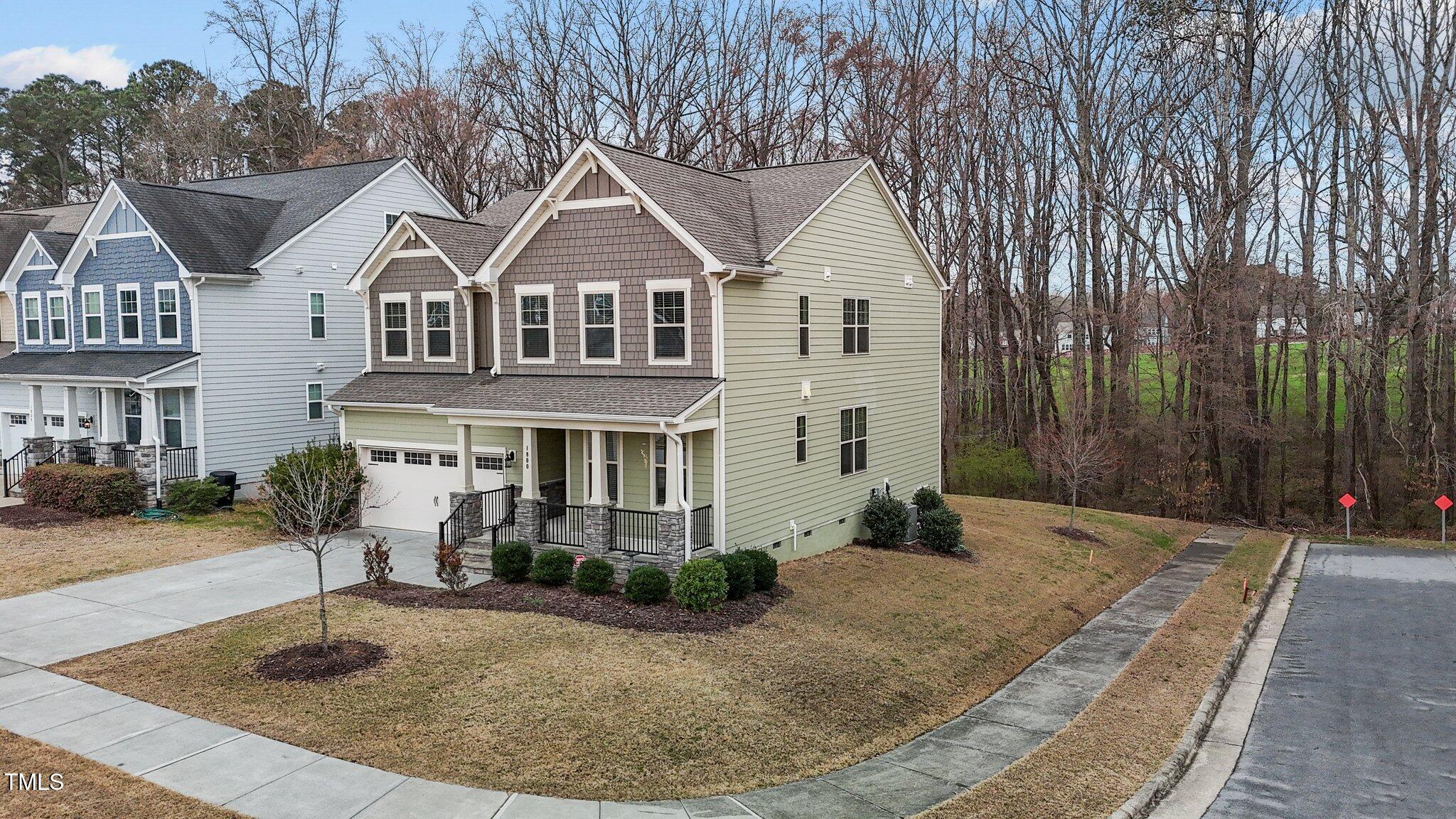 1800 Bodwin Lane Apex, NC 27502 - Photo 47 of 63 a view of a white house with large windows next to a yard